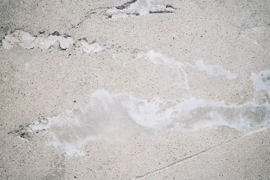 From above of textured background of rough surface with loose texture cracks and sand